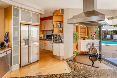 a kitchen with a stainless steel refrigerator and a stove at Erinvale Luxury Villa in Cape Town