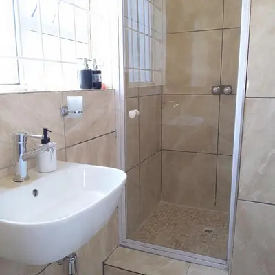 a bathroom with a shower and a sink at Naliya Guest house in Cape Town