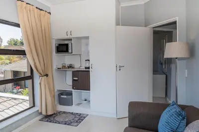 a living room with a couch and a window at Grandview Guesthouse in Cape Town