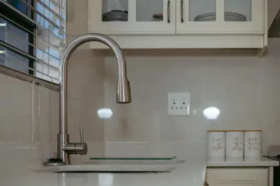 a kitchen with a sink and a faucet at Lovely and Peaceful 3 bedroom house in Cape Town