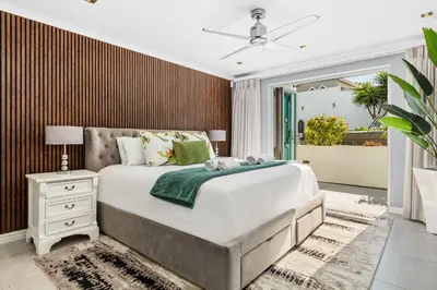 a bedroom with a large bed and a window at Rancho Relaxo in Bloubergstrand