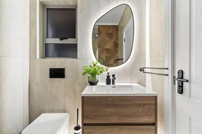 a bathroom with a sink and a mirror at Rancho Relaxo in Bloubergstrand