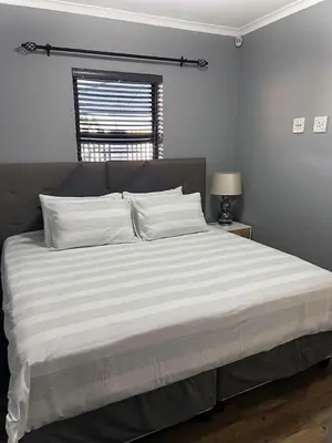 a large bed in a bedroom with a window at 81 on Groenewoud in Cape Town