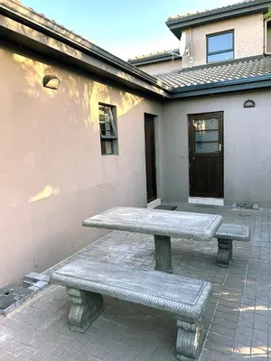 a stone bench sitting in front of a building at 81 on Groenewoud in Cape Town