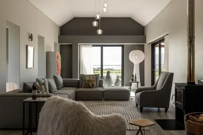 a living room with a couch and a chair at Benguela Cove - Utopia in Hermanus
