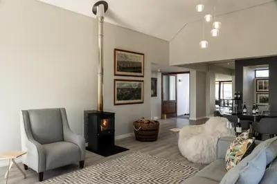 a living room with a couch and a fireplace at Benguela Cove - Utopia in Hermanus