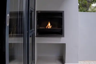 a fireplace in a wall with a fire in it at Stylish Studio Stellenbosch - Airconditioned in Stellenbosch