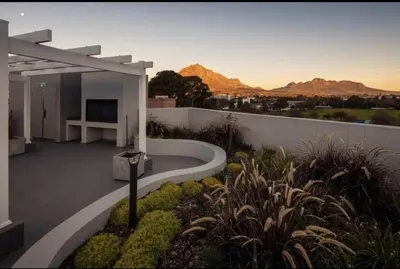 a balcony of a house with a view of the mountains at Stylish Studio Stellenbosch - Airconditioned in Stellenbosch