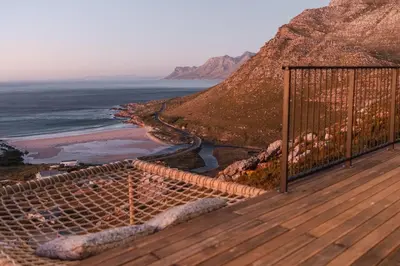 a wooden deck with a view of the ocean at Klein-Hangklip in Rooiels