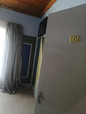 a door with a number on it in a room at ALEXIA LODGE & SPA in Cape Town