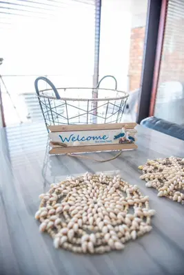 a table with a basket of beans and a bunch of nuts at Strand Apartment only 30 meters from beach in Cape Town