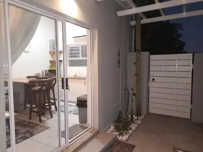 a kitchen with a sliding glass door and a table at Dalau on Main in Paarl