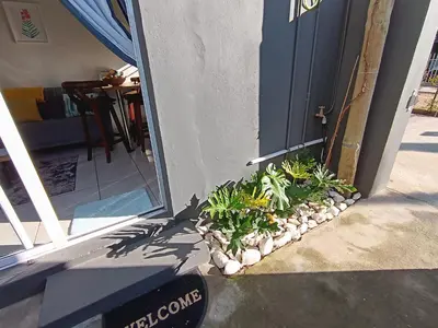 an open door with plants in front of a house at Dalau on Main in Paarl