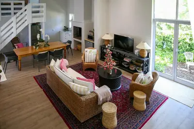 a living room with a couch and chairs and a table at Ivy House - Super Spacious Spot- Somerset West in Somerset West