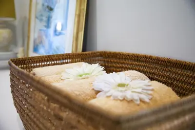 a wicker basket with two white flowers on it at Ivy House - Super Spacious Spot- Somerset West in Somerset West