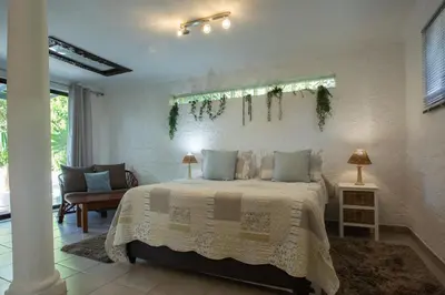 a bedroom with a bed in a room at Santika Getaway Cottage Stellenbosch in Stellenbosch