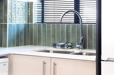 a kitchen with a sink and a window at The Xrossing - free parking in Stellenbosch