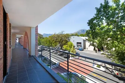 a balcony of a building with a view of a street at The Xrossing - free parking in Stellenbosch