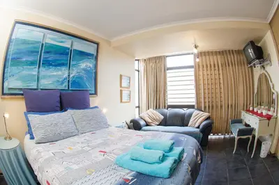 a bedroom with a bed and a couch at 5 Lantra in Strand