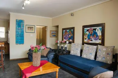 a living room with a blue couch and a table at 5 Lantra in Strand