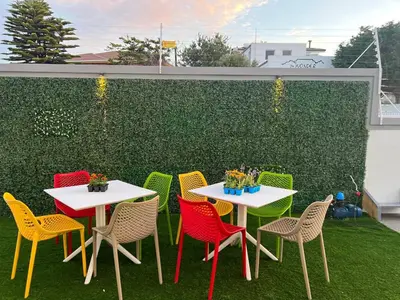 a group of tables and chairs on a patio at Ocean Vibes in Cape Town