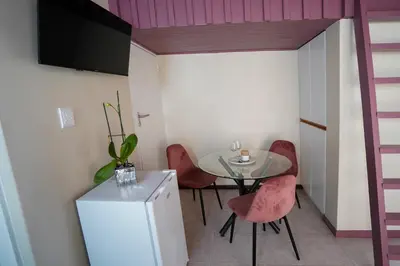 a small dining room with a table and chairs at Ocean Vibes in Cape Town
