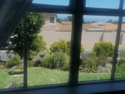 a view of a yard from a window at Hermanus Sea view room in Hermanus