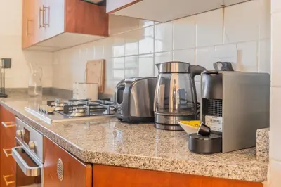 a kitchen with a counter top with a coffee maker at Secure and Modern 2Bed Apartment in Cape Towns Charming Rondebosch in Cape Town