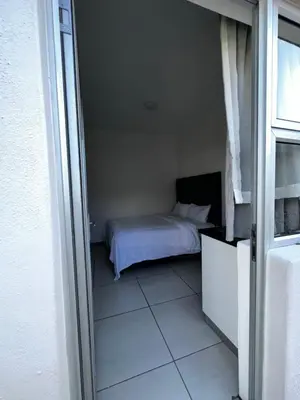 a bedroom with a bed in a small room at Beatrice Guesthouse in Cape Town