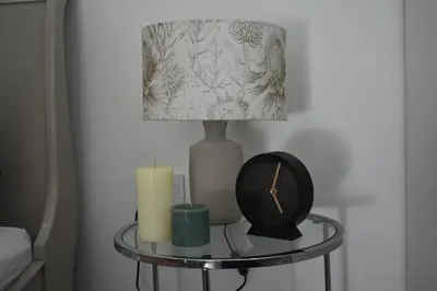 a table with a lamp and a candle and a clock at Langbeentjie Inn Two Point O in Cape Town