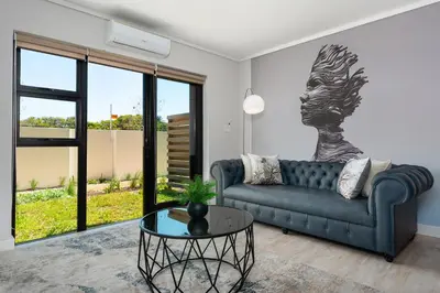 a living room with a couch and a table at Burmeister on Park 007 in Cape Town