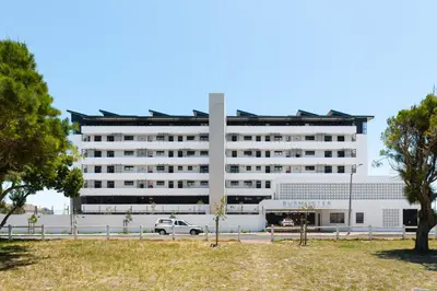 a white building with a car parked in front of it at Burmeister on Park 007 in Cape Town