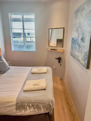 a bedroom with a bed with two towels on it at Kaneel Suiker - Paarl - Self Catering Apartment in Paarl