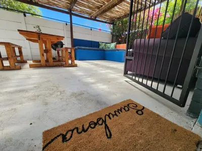 a welcome mat in front of a gate with a swing at A spacious Haven near Bloubergstrand beach in Cape Town