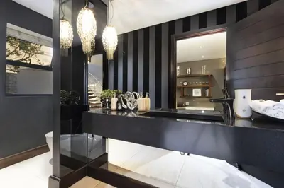 a kitchen with a black and white striped wall at Baronetcy Kings Villa in Plattekloof