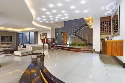 a living room with a staircase and a living room at Baronetcy Kings Villa in Plattekloof