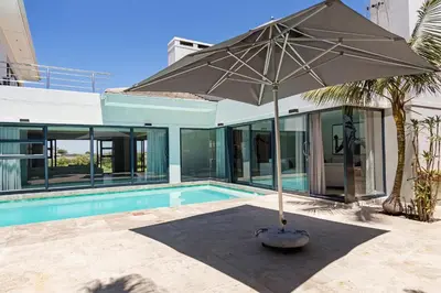 an umbrella sitting next to a swimming pool at Sunset Kite & Golf Villa in Cape Town