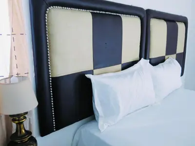 a bed with a blue and white headboard and pillows at 33 Goulborn street Goodwood in Cape Town