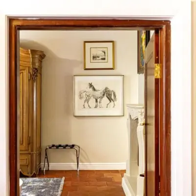 a hallway with two drawings of horses on the wall at Plaisir Estate Accommodation in Simondium