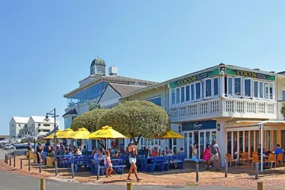a group of people walking in front of a building at Suidersee-Voelklip in Hermanus