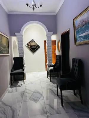 a room with three chairs and a painting on the wall at Mila Lodge 1 in Cape Town