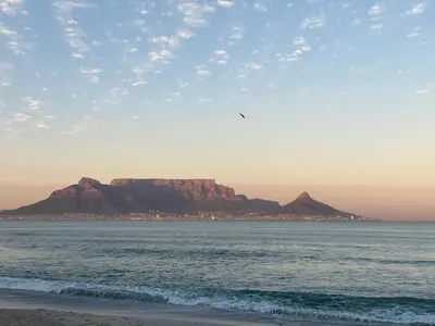 a view of a beach with a mountain in the background at Sleepy Tides in Cape Town
