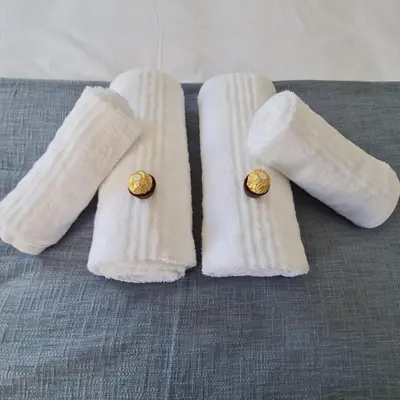 two white towels with rings on them on a table at 51 On Vlei in Cape Town