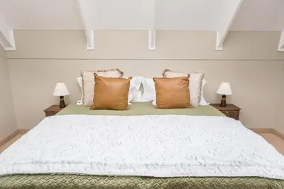 a bedroom with a large white bed with pillows at Eden-Paradys in Stellenbosch