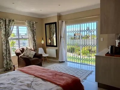 a bedroom with a bed and a sliding glass door at 22's Company in Cape Town