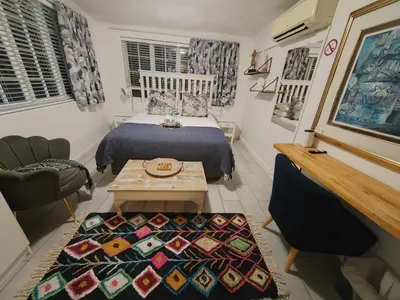 a small room with a bed and a table at La Damon 1 in Paarl