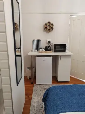a bedroom with a desk with a laptop on it at La Damon 2 in Paarl