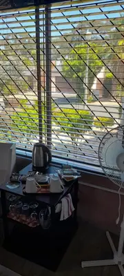 a room with a table in front of a large window at S & V Accommodation in Cape Town