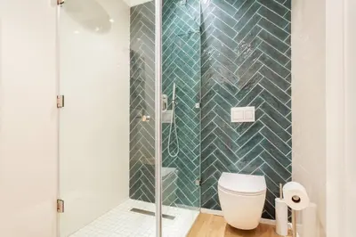 a bathroom with a toilet and a glass shower at Dolphin Beach cabana Luxe beach cabana voor 4 personen direct aan het strand in Table View
