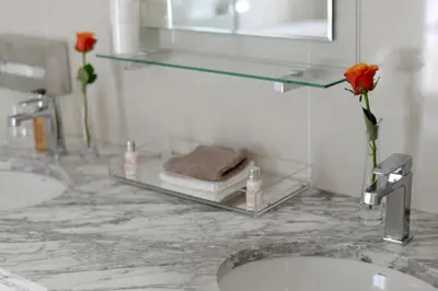 a bathroom with two sinks and a glass shelf at Farm Lorraine Lake Cottage, Loft Cottage and Garden Cottage in Franschhoek